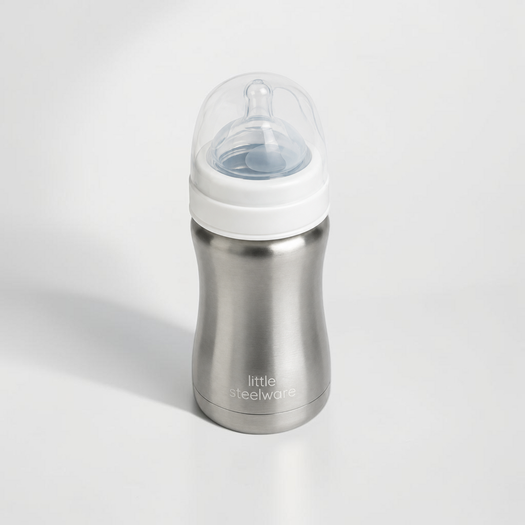 A stainless steel baby bottle with a white collar and a clear silicone nipple, branded 'little steelware' on the front, set against a clean white background.