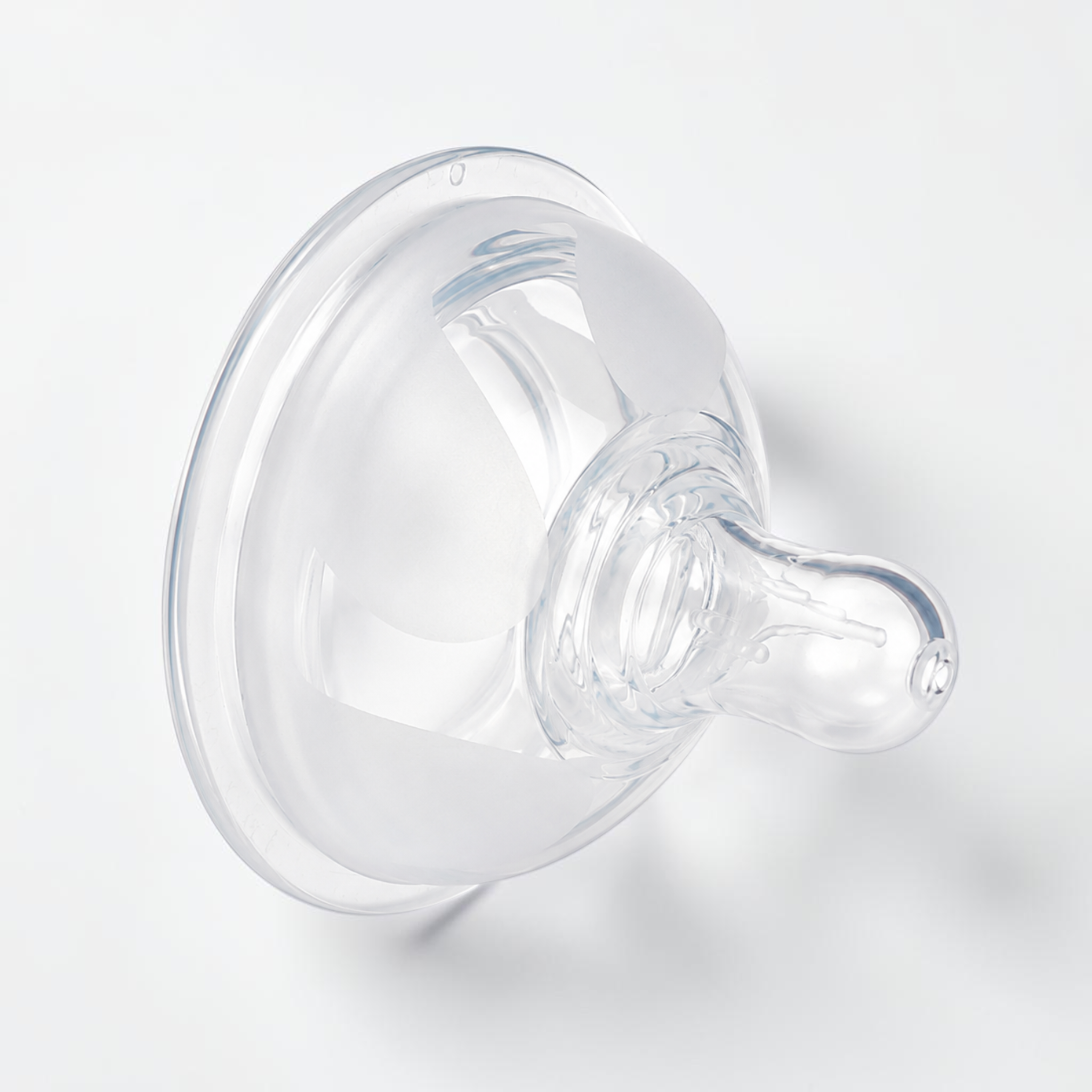 A clear silicone baby bottle nipple, photographed on a clean white background.